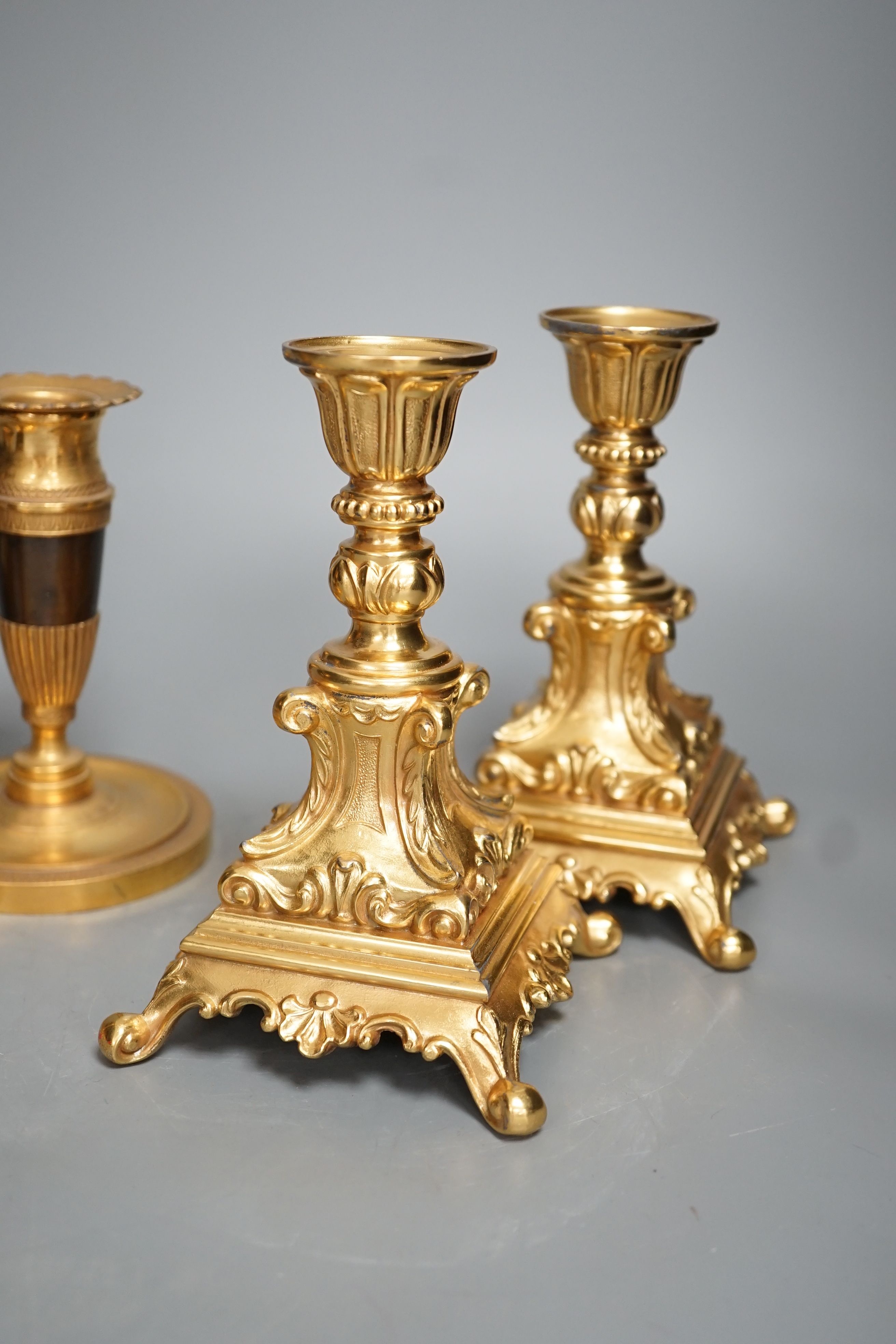 Three pairs of gilt metal candlesticks, tallest 16cm